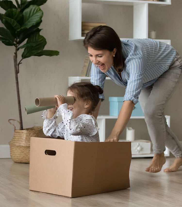 Mom & Daughter playing in a moving box